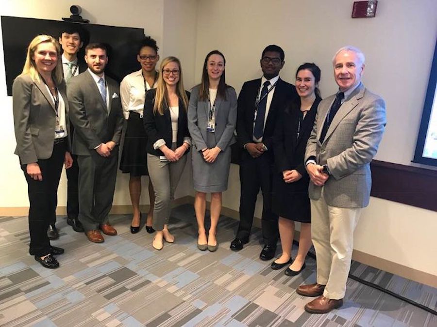 nine men and women in business attire