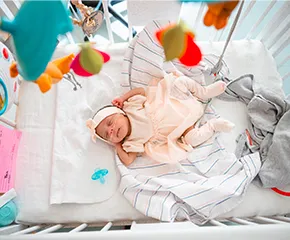 Newborn baby lay in hospital crib