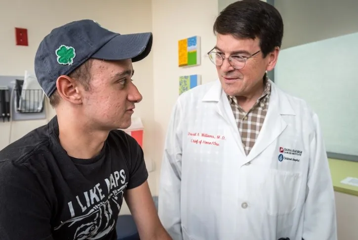 Dr. David Williams with a teen male patient in an exam room