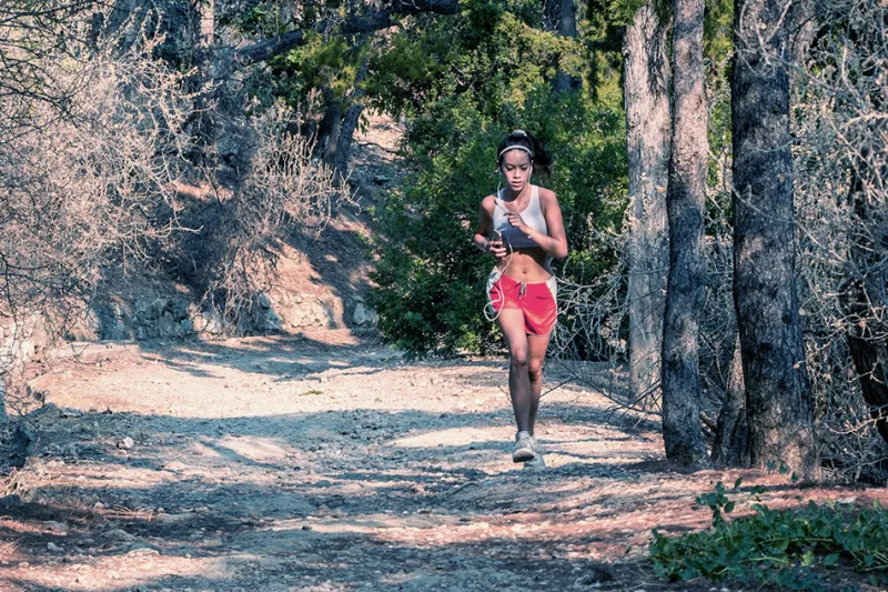 Female runner travels down path