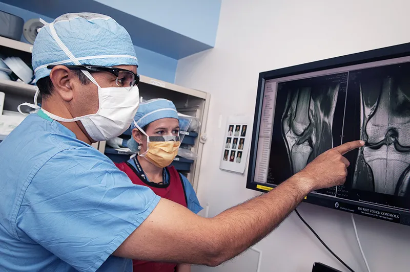 Clinicians look at imagery of a knee injury